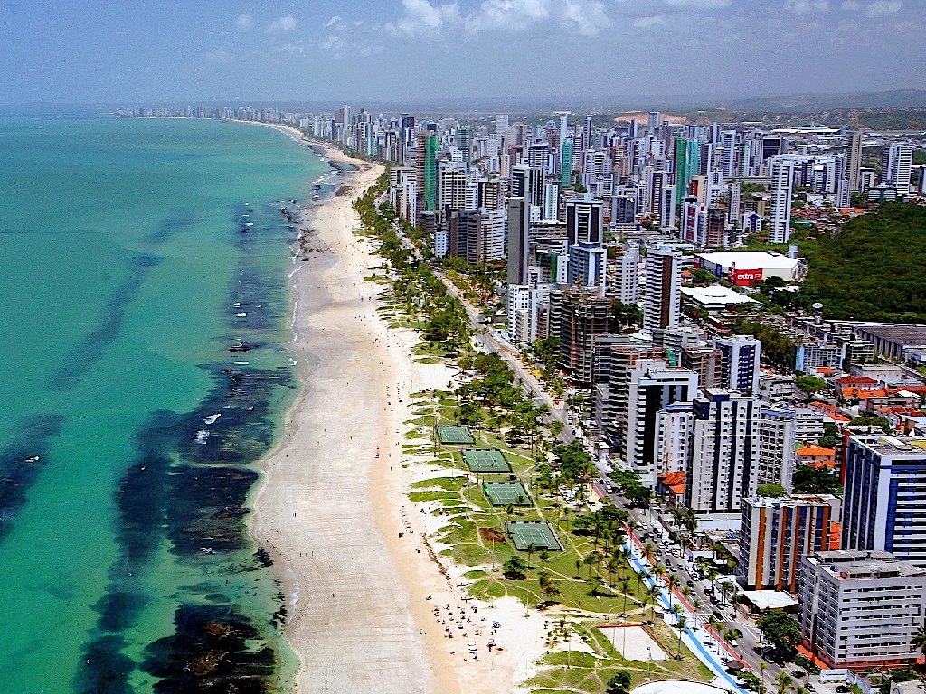 Aerial view of a turquoise coastline and beachfront skyscrapers in Recife -the best places to live in brazil