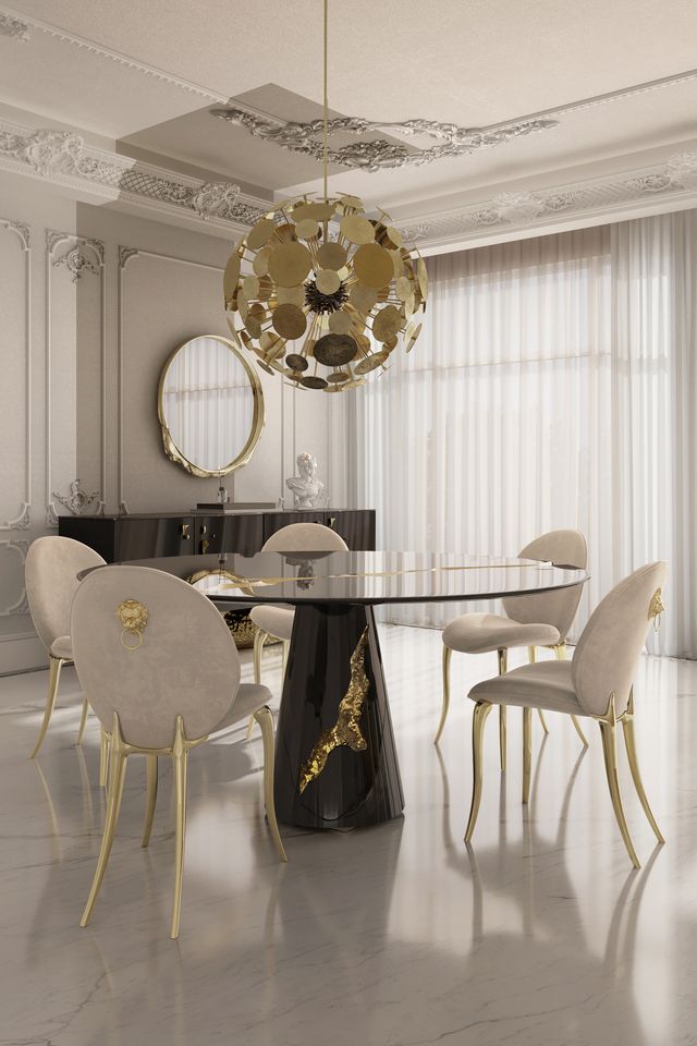 Round table with abstract black lacquer pedestal base beneath a gold disc sphere chandelier -luxury dining table