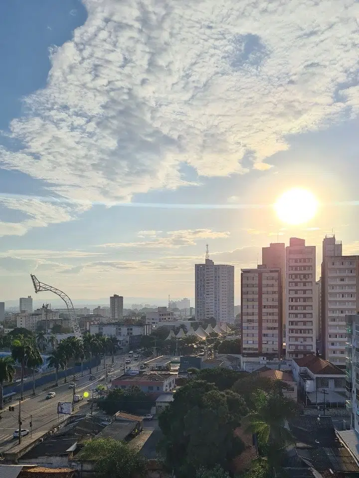 City skyline with buildings and a crane silhouetted against a sunrise sky -the best places to live in brazil