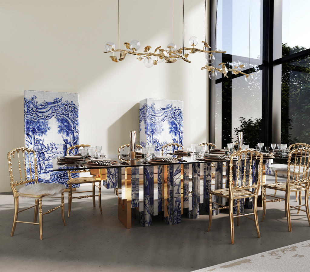 Glass-top dining table with blue-and-white azulejo tile and gold panel legs beside painted tile screens -luxury dining table