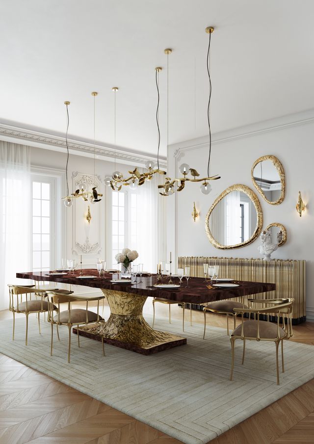 Rectangular burgundy stone-top table with sculptural gold hourglass pedestal in classic dining room -luxury dining table