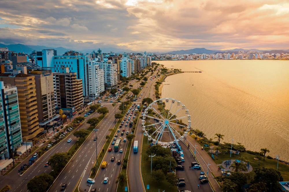 Ferris wheel and waterfront skyline along Beira-Mar Norte in Florianópolis at sunset -the best places to live in brazil