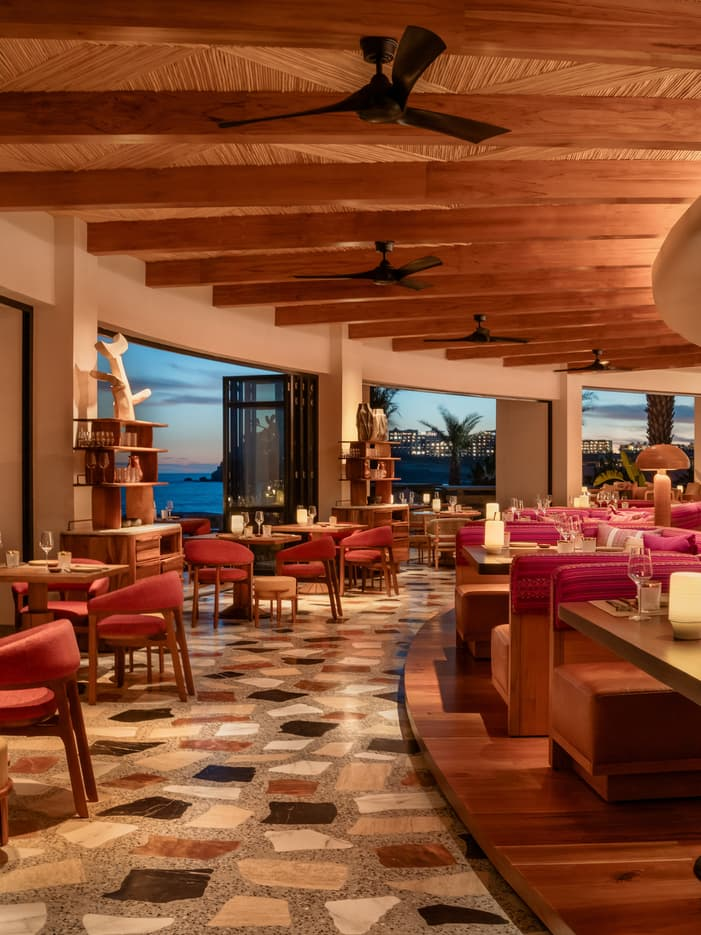 Warmly lit oceanview restaurant interior at Four Seasons Los Cabos