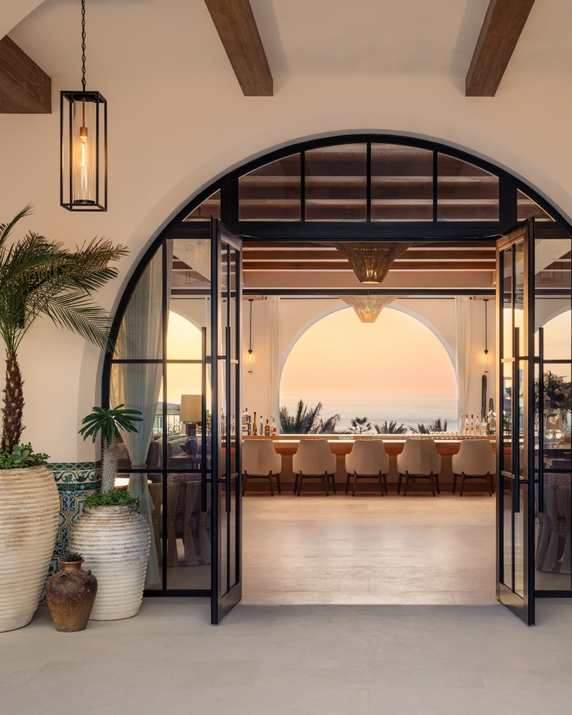 Arched entryway showing a sunset ocean view at Four Seasons Los Cabos