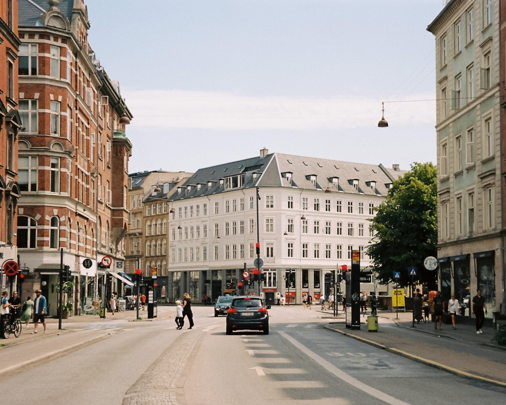 Classic white and red brick buildings on a quiet Copenhagen street -best places to live