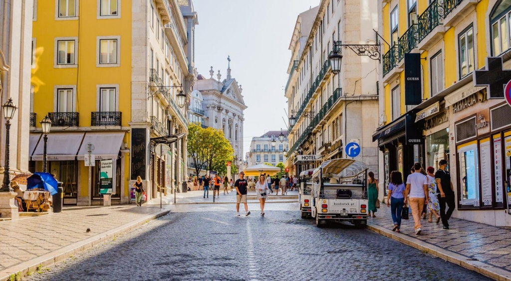 Colorful yellow buildings and cobblestone streets in Chiado, Lisbon -best places to live