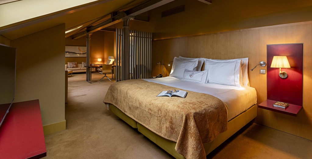 Luxury hotel suite with king bed and warm ambient lighting -pestana