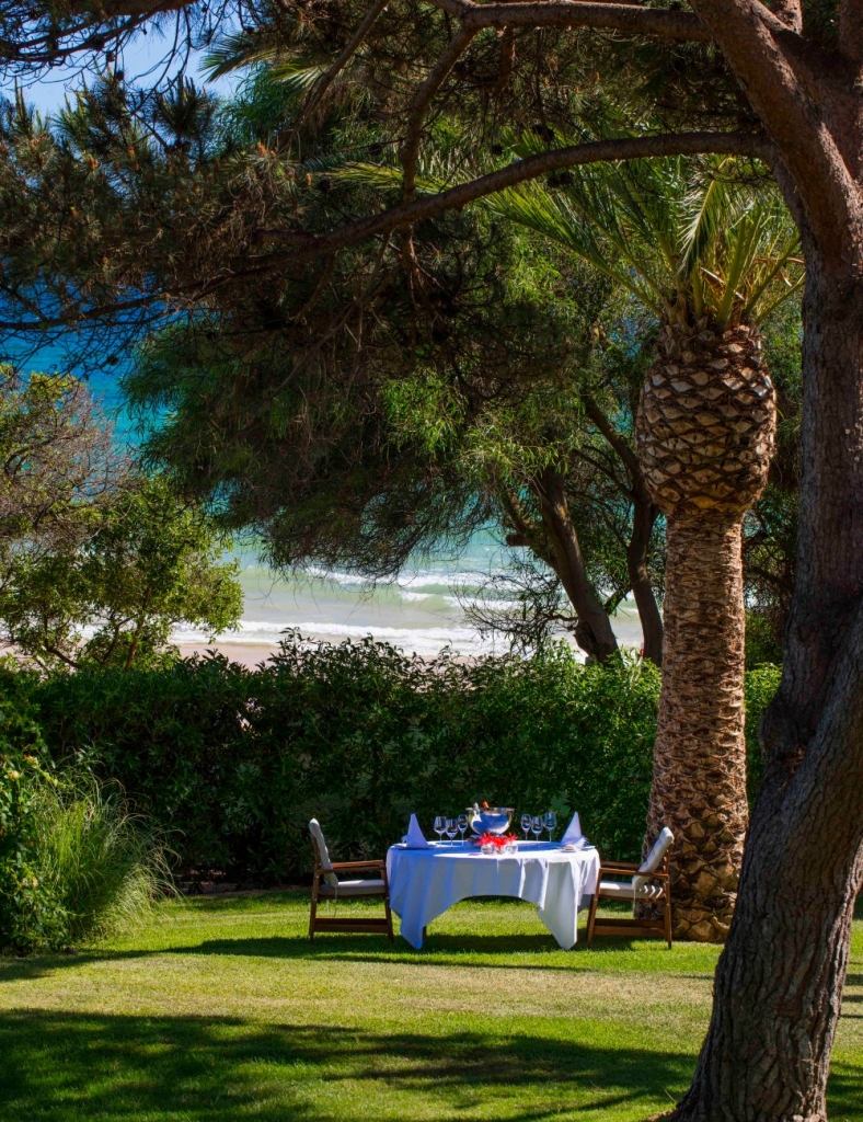 Michelin Experiences in Portugal – Vila Joya outdoor lunch table in a garden overlooking the Atlantic Ocean in the Algarve