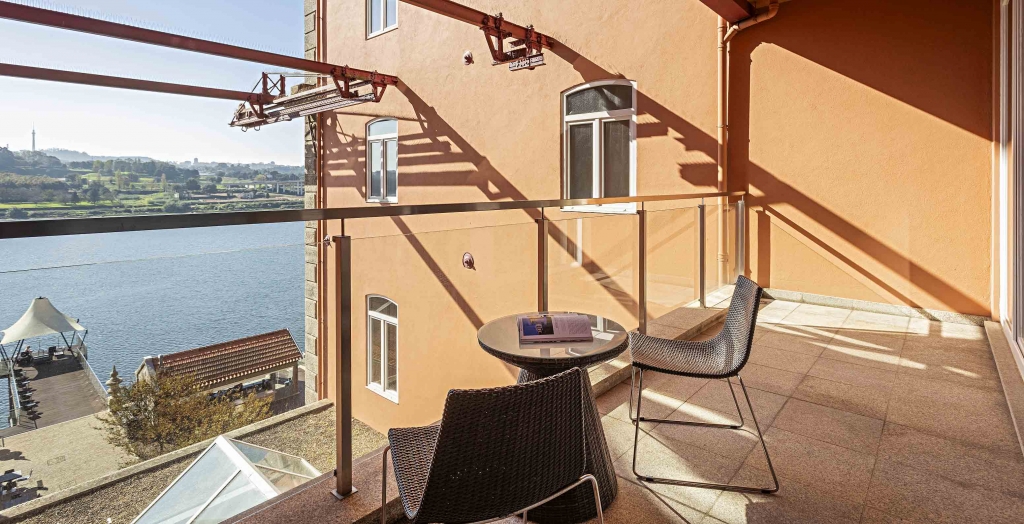 Private balcony with river view and outdoor seating area -pestana