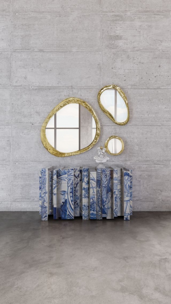 Organic-shaped gold-framed mirrors above a sideboard decorated with blue and white Portuguese tile motifs - fall winter 2027 trends