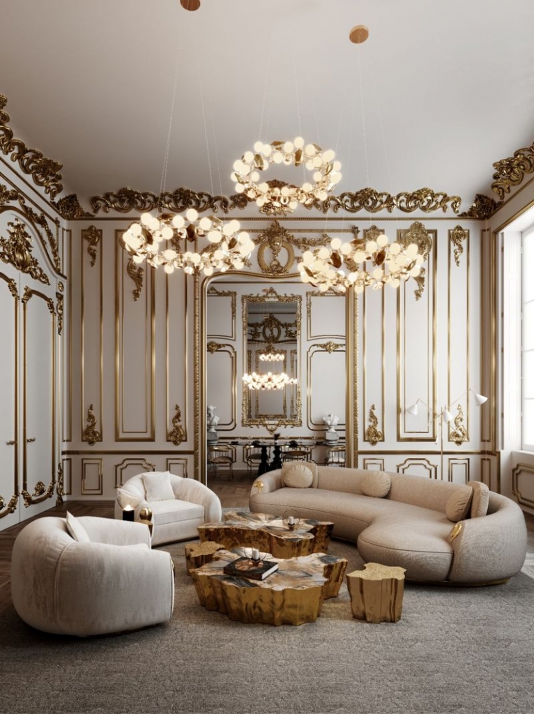 Classic French-style living room with gilded boiserie, curved beige sofa and sculptural gold coffee tables - fall winter 2027 trends