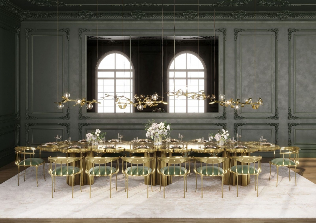 Sophisticated dark green dining room with a wavy gold table, brass chairs and branch-like pendant lights - fall winter 2027 trends
