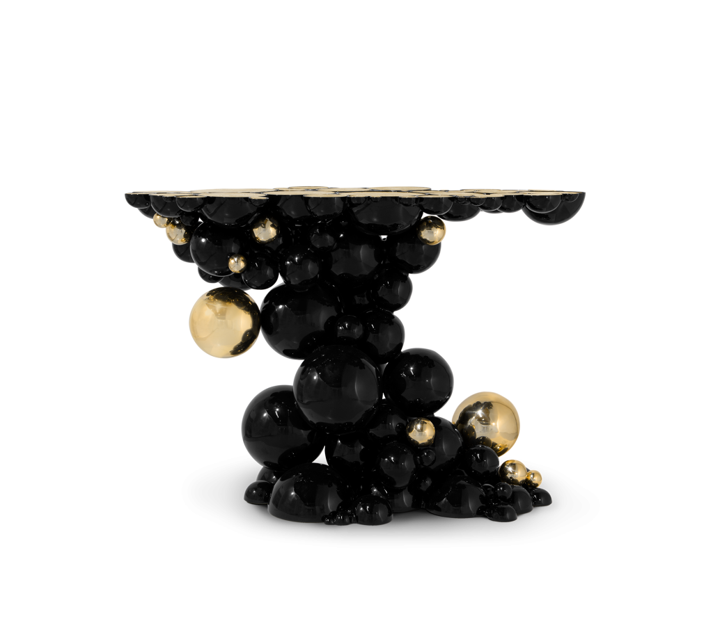 Sculptural side table composed of overlapping black and gold spheres - fall winter 2027 trends