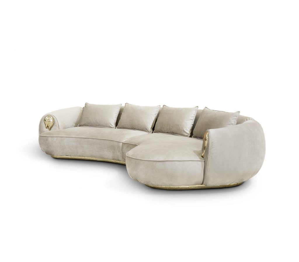 Light beige velvet sectional sofa with sculptural gold detailing on the arms - fall winter 2027 trends
