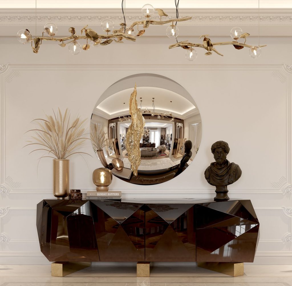 Contemporary Living Room Ideas focusing on a sophisticated entryway sideboard in dark glossy finish with faceted details, paired with a large round convex wall mirror, golden branch lighting, and a classical bust sculpture.