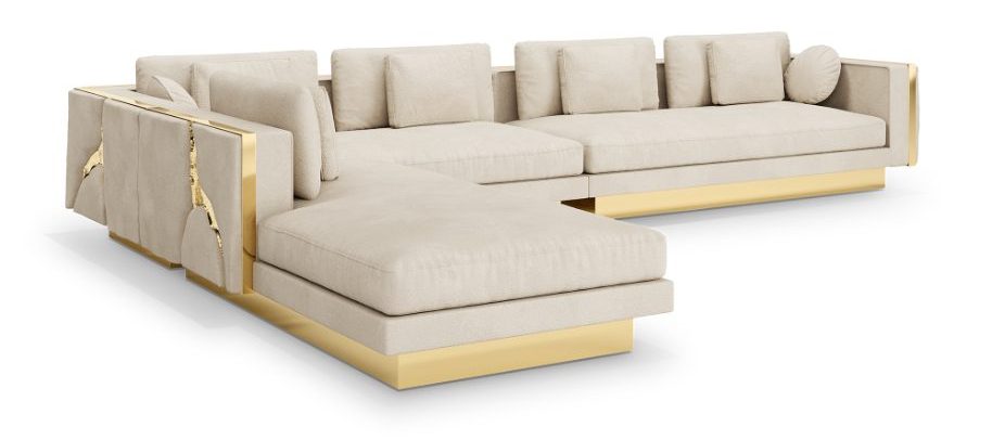 Light beige fabric sectional corner sofa with a gold metallic base and details, featuring a luxurious and contemporary design.