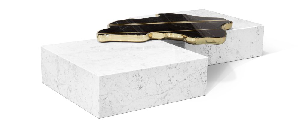 Luxury coffee table consisting of two white marble rectangular bases and an organic black marble top with gold details.