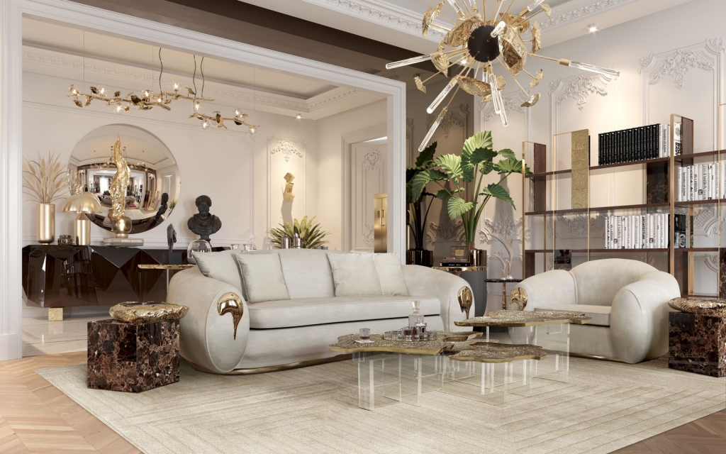 Sophisticated living room with a beige sofa, gold accent coffee tables, and a dark sideboard with gold sculptural details visible in the background – statement sideboard.